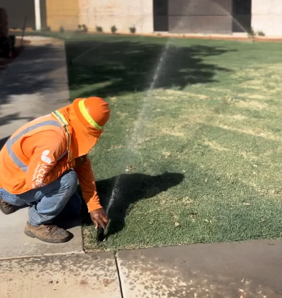 Crew member adjusting a Sprinkler Head